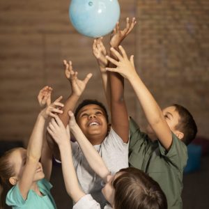 medium-shot-kids-playing-with-ball